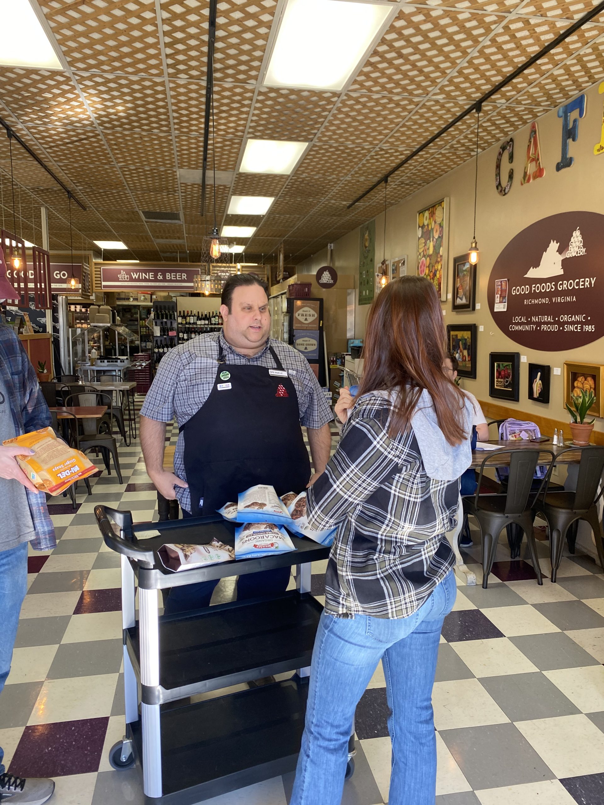 intern for career readiness and employment speaking to job coach, ella, at Good Foods grocery cafe